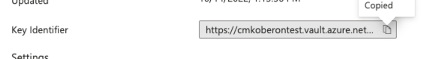 Key Identifier fields showing the URI for https://cmkoberontest.vault.azure.net